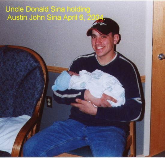April 2004: Donald Sina holding his new nephew at the hospital.