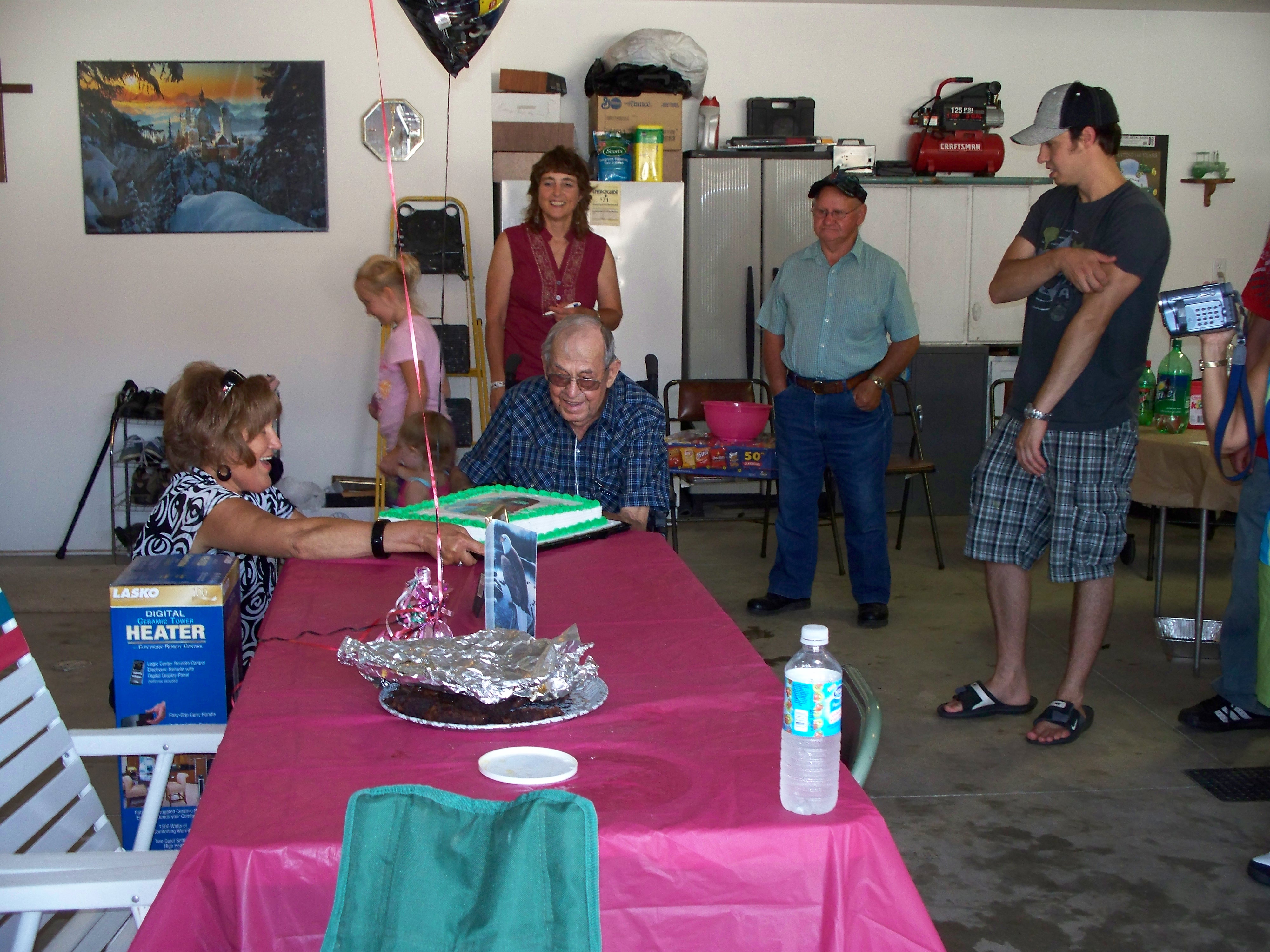 Loretta presenting the cake on Edmund on his 87 birthday