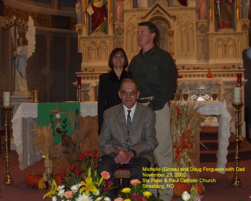 Michelle (Gross) and Doug Ferguson with Dad, Ermina's Funeral, November 23, 2002 at Sts. Peter and Paul Catholic Church, Strasburg, ND