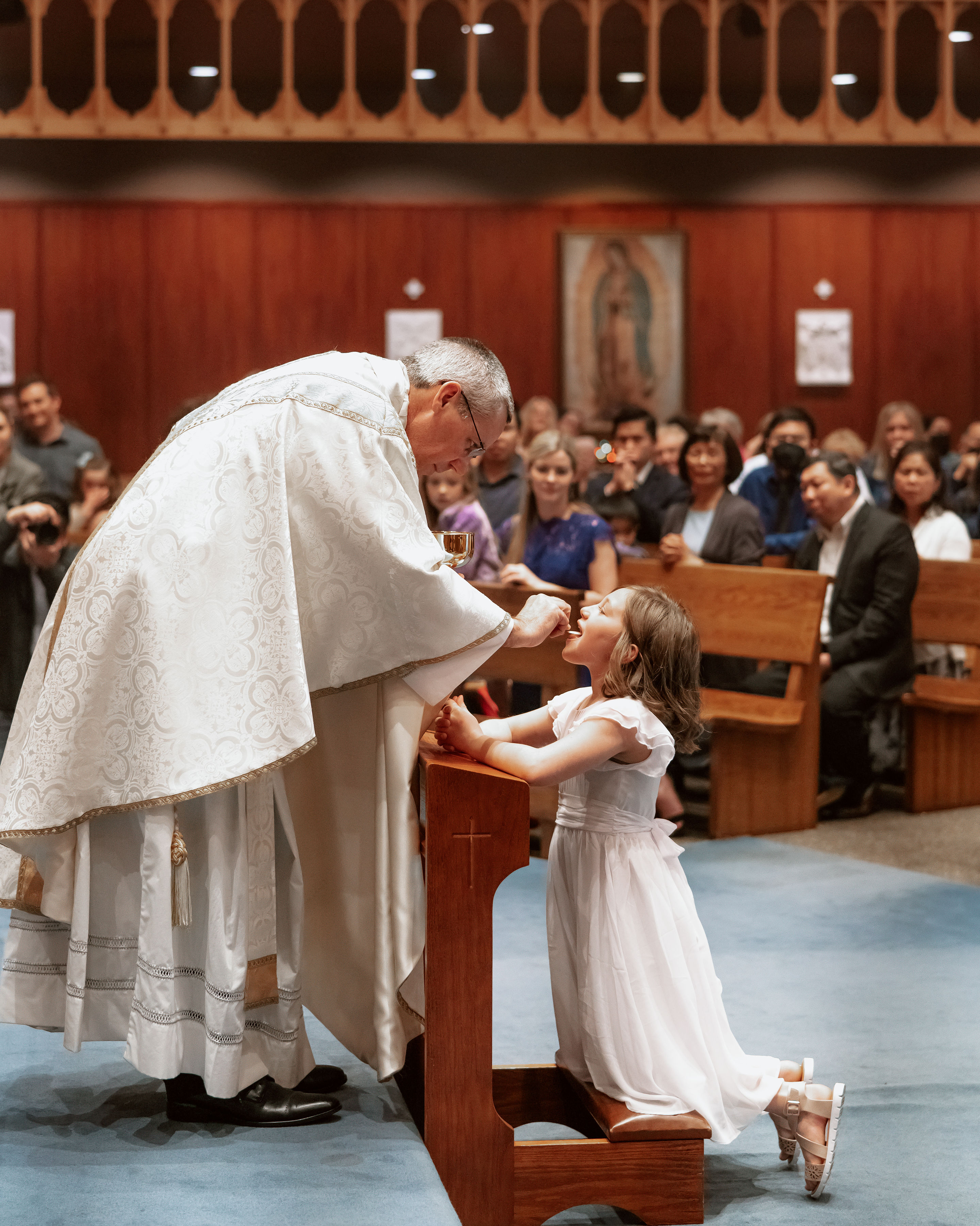 May 1, 2022:  Paisley Lynn Boullet receiving the Holy Eucharist from Msgr. John Cihak.