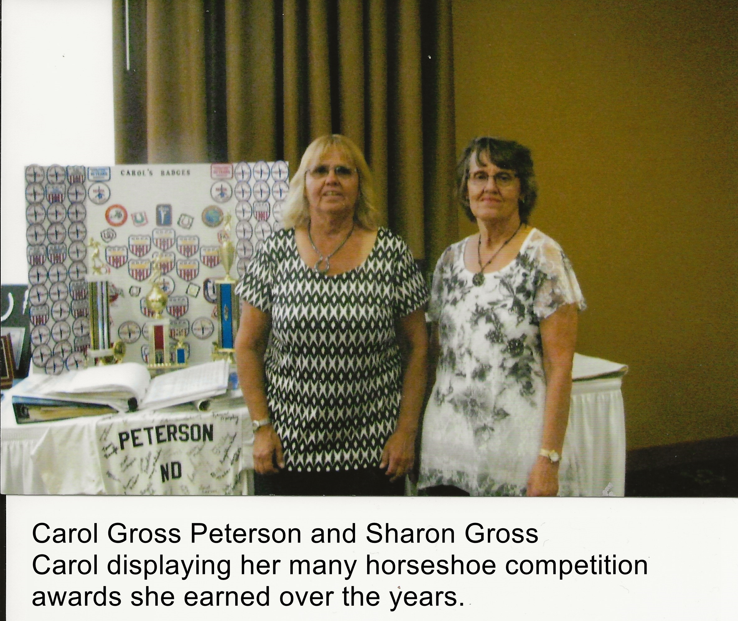 Carol and Sharon.  Carol displaying her many awards she earned in horseshoe throwing competition.