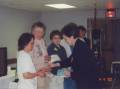 Marianna Dosch membership chair placing a medal, Immaculate Conception prayer card along with the program into the hand of Sharon Gross, April 2005