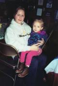 Kayla holding Kassidy at the ice skating ring, 2001