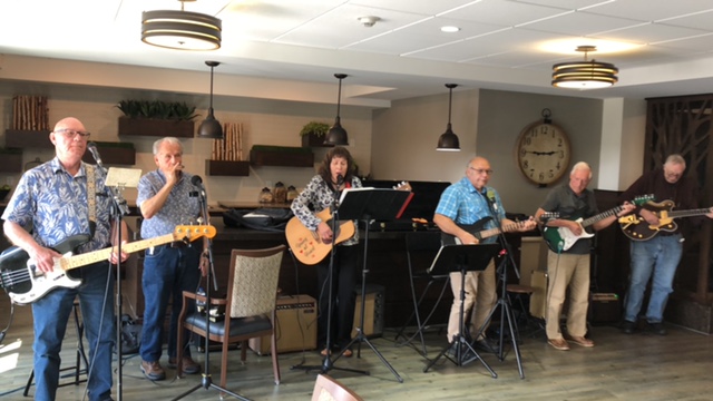 July 2023 Leo Heier 2nd from left playing harmonica.